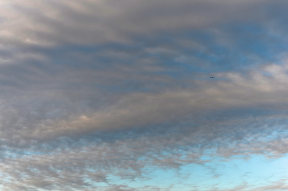 Plane flying in the cloudy sky