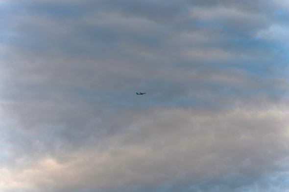 Plane flying in the cloudy sky
