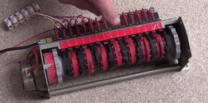 Tim Hunkin explaining to operation of a cam timer mechanism. It is essentially a geared motor turning a shaft on which are mounted several cams that operate various limit switches, opening and closing electrical contacts
