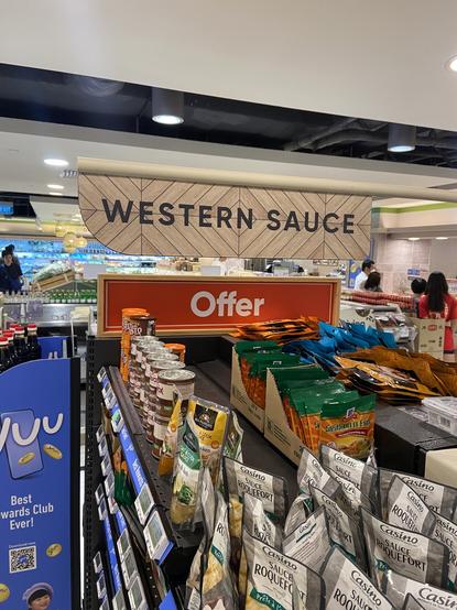 Supermarket aisle labeled “Western Sauce” with another sign under it saying “Offer”