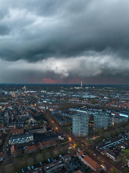 Dramatic thunderclouds above Hilversum. A little bit of sunset red glow can be seen at the horizon.