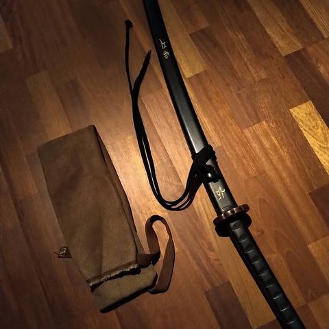 My near black panacoco heartwood bokken on a brown parquet floor. 
Weight and dimensions are exactly the same as my daitō (katana).