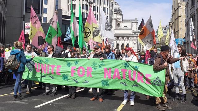 Big march on the streets, banner saying 'Unite for Nature'