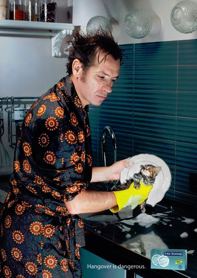 Man washing the dishes after the hangover.
Instead of a a sponge, there's a smol kitten in his hand... (photoshopped)