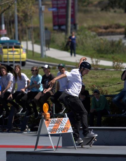 Skateboarder, working obstacle course.