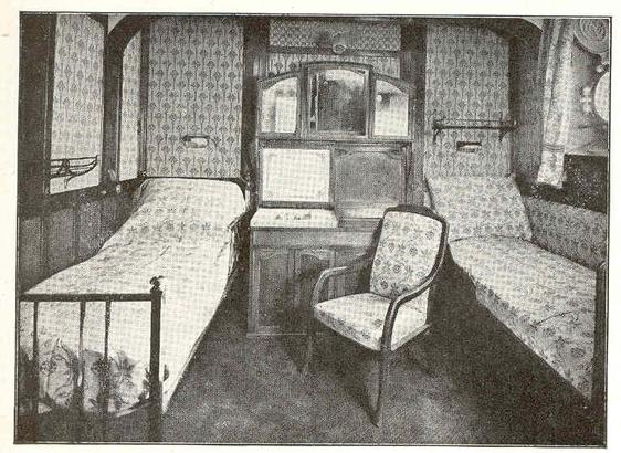 Stateroom aboard the SS France, 1912. Second class? There are two beds (not berths), one on the outboard wall, one inboard. The wall coverings, probably of fabric, have a pattern that complements the bedspreads and upholstery. There are twin washbasins between the beds. Not quite Baroque style, but comfortable for the time.