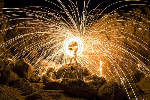 Explosion! by Riccardo Cuppini on Flickr: photo of a human figure in the center of a long-exposure explosion that looks like fireworks
