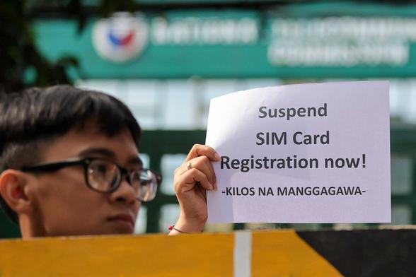 Groups opposed to the government's SIM registration program picket the National Telecommunications Commission headquarters in Quezon City to demand a stop to the registration process, on January 11, 2023.