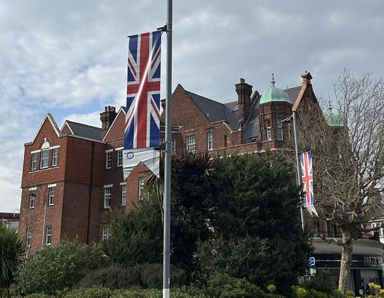 Union jack flags, hanging long rectangular plastic banners, outside Eastbourne library