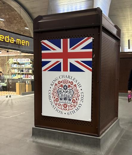 One of many big, prominent signs at London Bridge Station, with a union jack and a celebratory logo for the coronation of King Charles III 2023