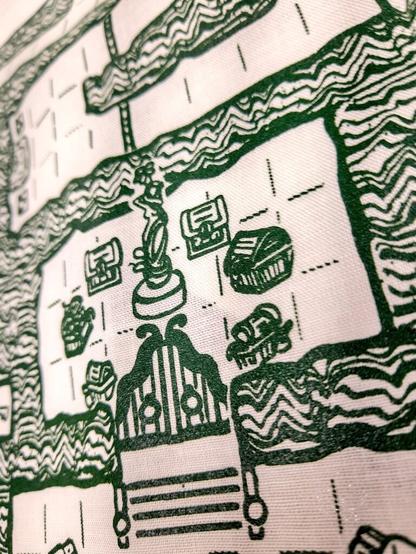 A close-up of the print showing treasure chests and a statue that may or may not br weirdly reminiscent of Dibella from Skyrim