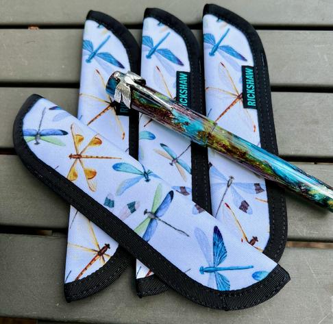 Kelmscott Dragonfly Special Edition, resting on a collection of the custom Rickshaw Bagworks pen sleeves made for the special pen.