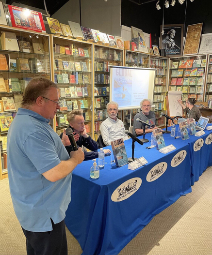 Four dudes at a table.