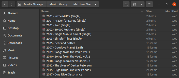 A Nautilus file manager window shows a folder full of Matthew Ebel's music.