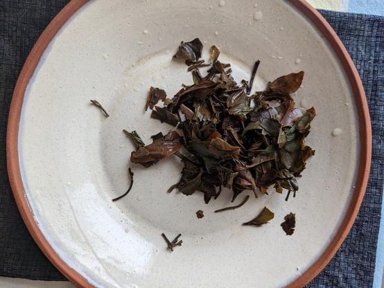 Spent tea leaves on a plate.