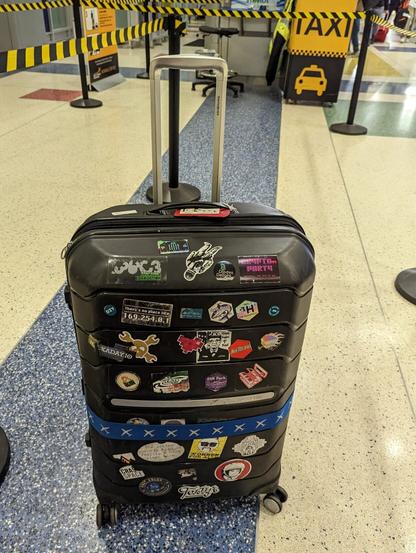 Suitcase with lots of hacker stickers