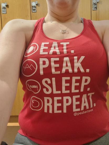 Ruth wearing a red vest that says "Eat, Peak, Sleep, Repeat" on it.