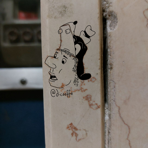 guy with a big nose, open mouth and Disney's goofy hat over the photo of a marble