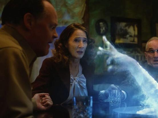 A ghostly finger points at a séance