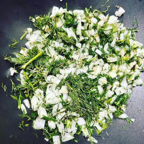 Herbs, onions, and garlic being sauteed