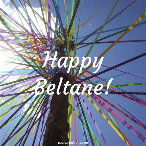 Image looking up at a maypole with the words "Happy Beltane!" Imposed on it.
