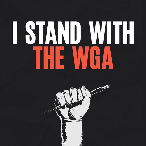 Black background with white and orange text: "I STAND WITH THE WGA". Below text, a drawing of a fist around a fountain pen.