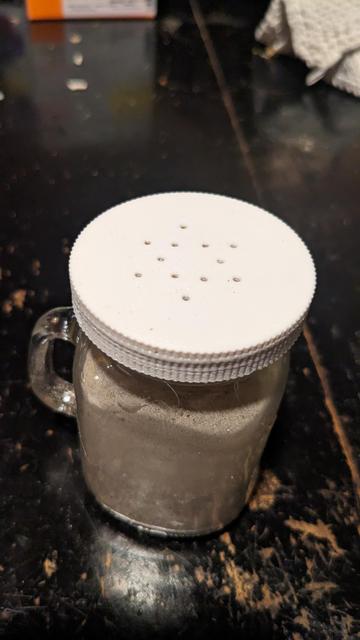 A 3D printed replacement pepper shaker lid freshly screwed onto the pepper shaker.