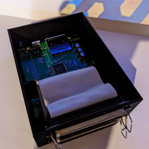 A 3d printed case with a SCSI2SD adapter inside. A ribbon cable connected to the internal 50 pins that exposes 2 old -school SCSI ports on the outside, allowing to daisy-chain things.