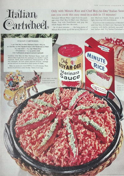 A large pot has rice, tomato, marinara sauce, something green, and hotdogs. The most unappealing looking dish. ￼
