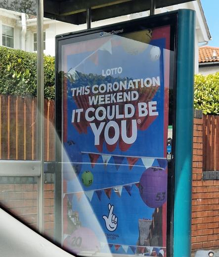 Bus stop poster advertising the National Lottery saying "This coronation weekend, it could be you"