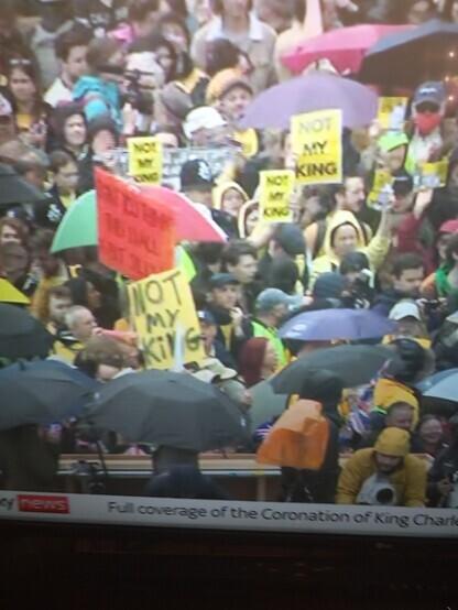 Yellow anti-monarchy posters saying Not My King