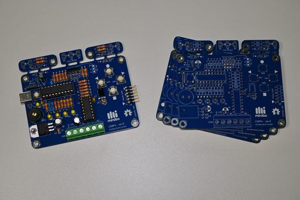 An assembled CHRP4 (left) and four blank CHRP4 printed circuit boards (right).