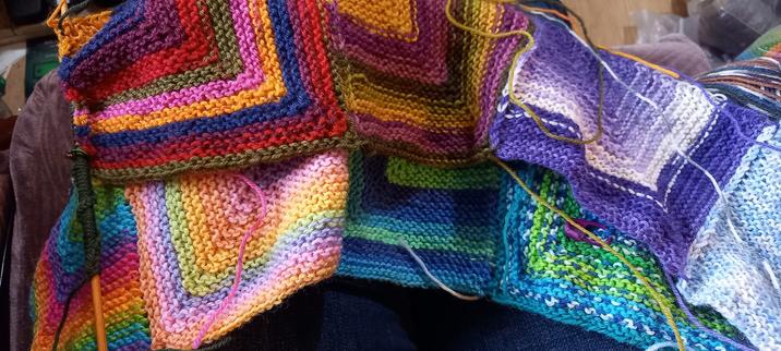 Photo shows my mitre square wip blanket, the Everyday Knitter Confort Blanket, in West Yorkshire Spinners yarns.