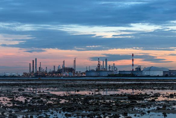 Pulau Bukom, a petrochemical refinery island operated by Shell, with Terumbu Semakau (a patch reef) in the foreground.