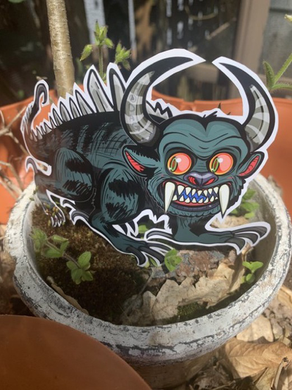 @samkalensky a bull like creature stands in a flowerpot smiling at you