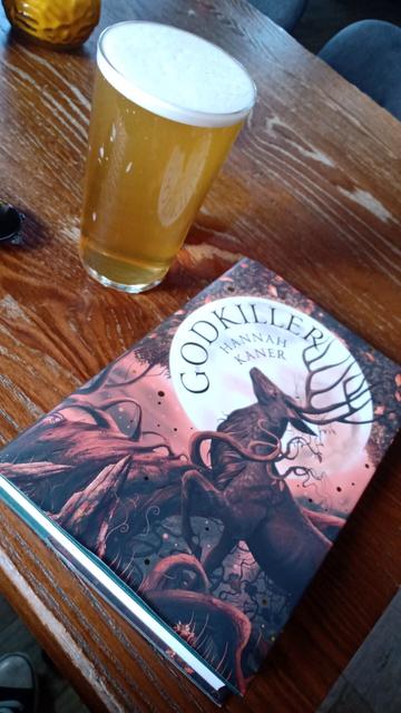 Copy of Hannah Kaner's Godkiller with pint of ale, on pub table