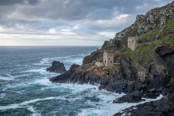 Botallack in Cornwall.  Seascape scene with rugged rocky coastline and two tin mines perched on the cliff edge known as The Crowns