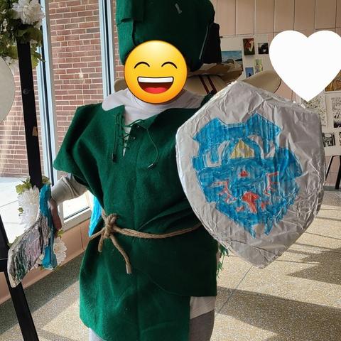 Photograph of a teenager in a Link costume made out of recycled materials.