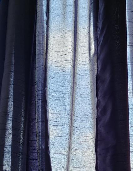 Sky through blue sheer curtains