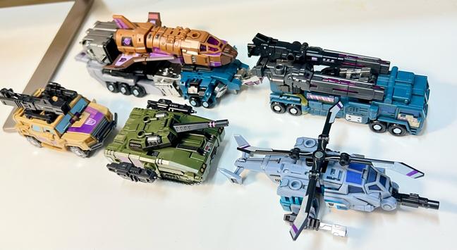 The Combaticons in alt mode with all their weapons attached