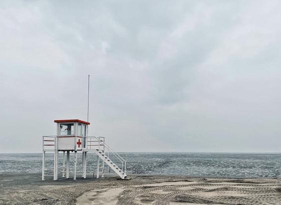 Low-key shot of an unoccupied lifeguard tower on the beach of Harlesiel on the German North Sea coast in winter.