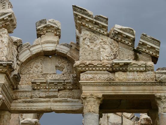 Highly ornamented gateway, at Aphrodisias. A signature architectural monument with Corinthian columns, and elaborate foliate carving on the pediment and arch.