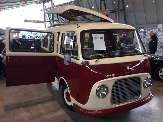 Maroon and white two-tone Taunus Transit Westfalia camper van front quarter view