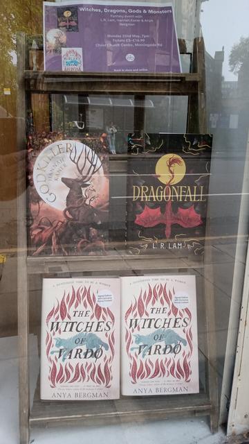 Edinburgh Bookshop window display of Hannah Kaner's Godkiller, L.R. Lam's Dragonfall and Anya Bergman's Witches of Vardo for an upcoming all-women author event.