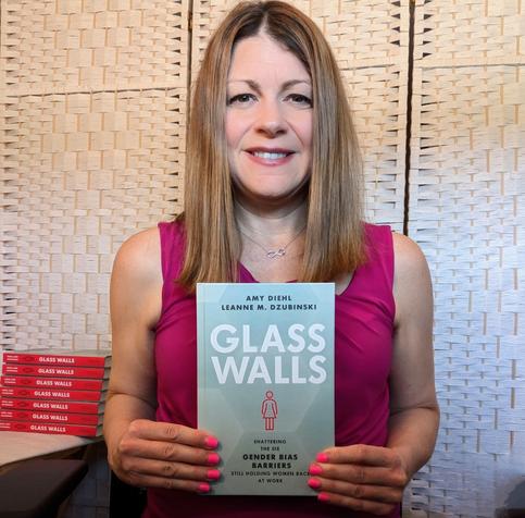 Dr Amy Diehl holding her new book GLASS WALLS