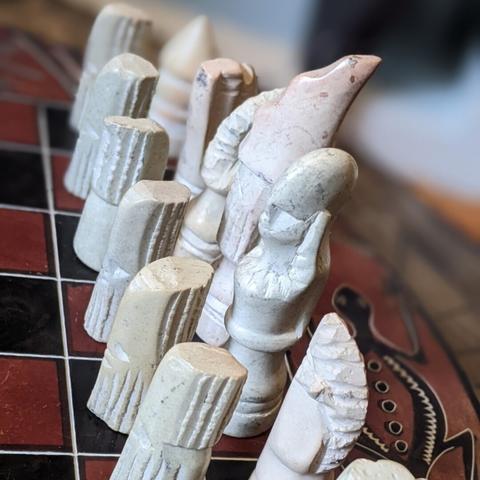 a closeup of a white chess set.