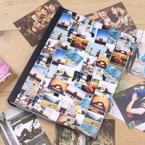 A photograph album with a selection of loose photographs around the outside waiting to be placed inside.