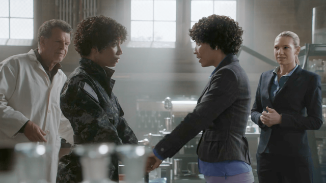 A screengrab from a Fringe episode showing the first meeting of autistic Agent Astrid Farnsworth, from the Amber World, and neurotypical Agent Astrid Farnsworth, from the Prime World.

In the background are Doctor Walter Bishop and FBI Detective Olivia Dunham.
