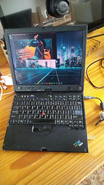 An old worn Thinkpad X61T running Elive RetroWave special edition.