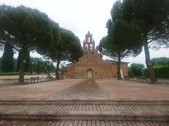 The local church, typical of the area, is built from red bricks and has bells in arcades in a steeple-wall, instead of the bell tower you'd find elsewhere. It also has a relatively large forecourt with trees on either side